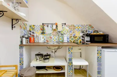 a kitchen with a counter with a sink in a room at Antico vicolo di ballarò in Palermo