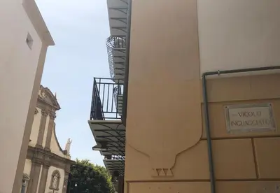 a building with a sign on the side of it at Antico vicolo di ballarò in Palermo