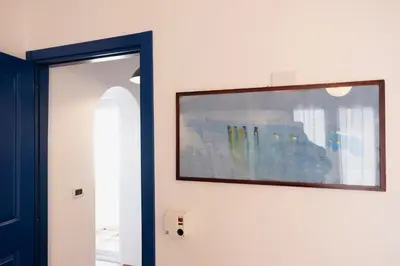 a picture hanging on a wall next to a mirror at Villa Blumarine sul mare in San Vito lo Capo