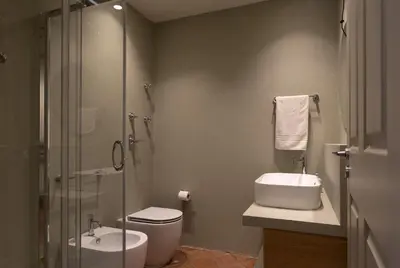 a bathroom with a toilet and a sink and a shower at Villa Turchese sul mare in San Vito lo Capo