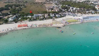 an aerial view of a beach with a crowd of people at Villa Turchese sul mare in San Vito lo Capo