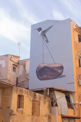 a picture of a bird on a sign on a building at A Casa del Genio in Palermo