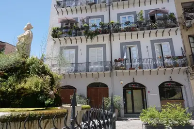a building with a statue in front of it at A Casa del Genio in Palermo