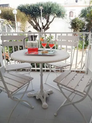 a table and two chairs on a patio at villa coral mondello in Palermo