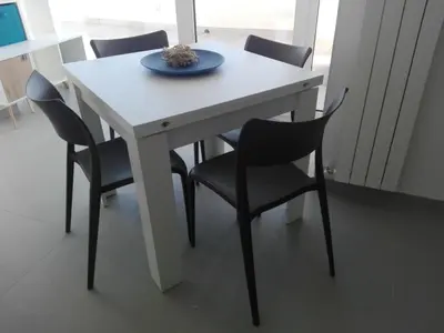 a white table with chairs and a plate on it at Appartamento Sul Golfo in Castellammare del Golfo