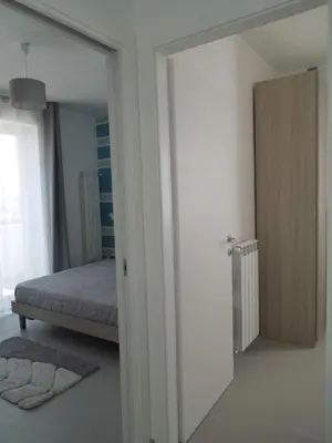 a bedroom with a mirror and a bed in it at Appartamento Sul Golfo in Castellammare del Golfo