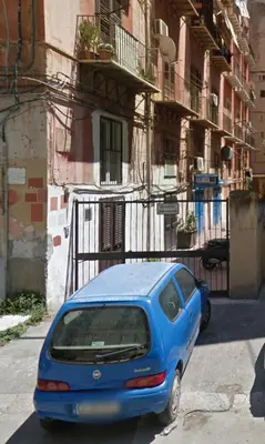 a blue car parked on the side of a street at HoliDay in Palermo