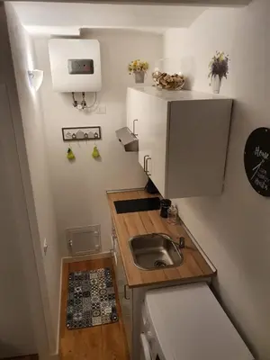 a small kitchen with a sink and a counter at HoliDay in Palermo