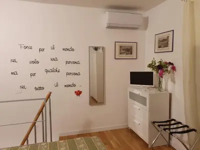 a room with a wall with writing on the wall at HoliDay in Palermo