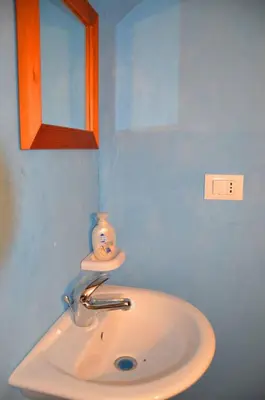 a white sink in a bathroom with a mirror at Villa Fraginesi in Castellammare del Golfo