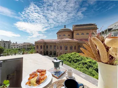 a table with a plate of food on top of a building at Solemar Sicilia - Palazzo Massimo in Palermo