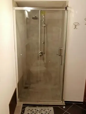 a shower with a glass door in a bathroom at Mix&Match in Palermo