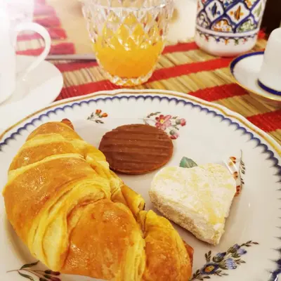 a plate of food with a croissant and bread at Mix&Match in Palermo