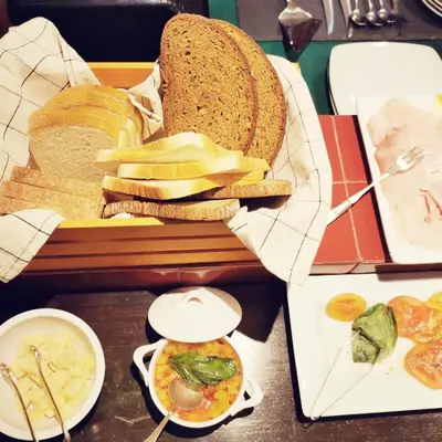 a table with a tray of bread and other foods at Mix&Match in Palermo
