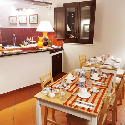 a dining room table with chairs and a kitchen at Mix&Match in Palermo