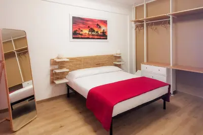 a small bedroom with a bed and a mirror at Elite Residence Mondello in Mondello
