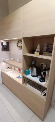 a kitchen with a wooden cabinet filled with food at B&B AMISTANZA in Palermo