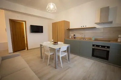a kitchen with a table and chairs in a room at Casa Vacanza Barone in Castellammare del Golfo