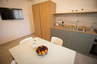 a kitchen with a table with a bowl of fruit on it at Casa Vacanza Barone in Castellammare del Golfo