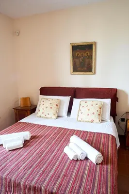 a bedroom with a bed with two towels on it at LuminHouse Mondello Valdesi in Palermo