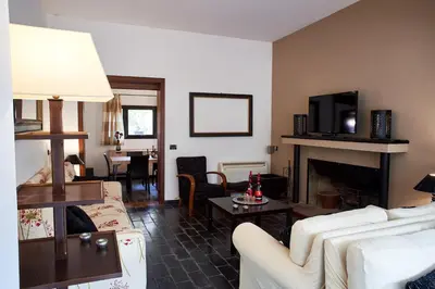 a living room with white furniture and a fireplace at LuminHouse Mondello Valdesi in Palermo