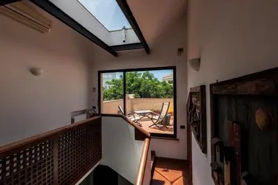 a room with a balcony with a large window at LuminHouse Mondello Valdesi in Palermo