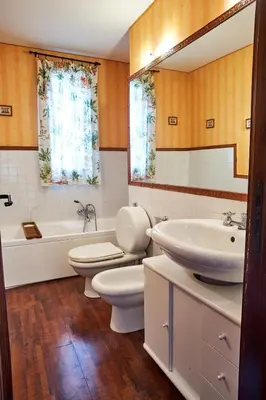 a bathroom with two toilets and a tub and a sink at LuminHouse Mondello Valdesi in Palermo