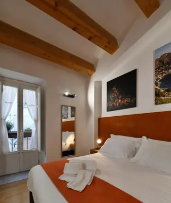 a bedroom with a large white bed and a window at Ballarooms B&B Palermo Centro in Palermo