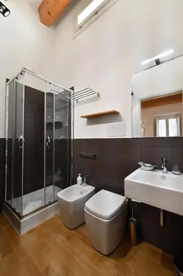 a bathroom with a toilet and a sink and a shower at Ballarooms B&B Palermo Centro in Palermo