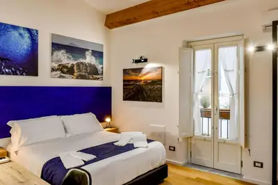 a bedroom with a large bed and a window at Ballarooms B&B Palermo Centro in Palermo