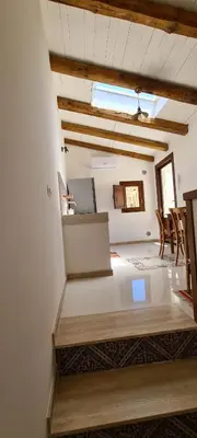a room with a bed in a room with chairs at Voltamare in Castellammare del Golfo