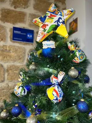 a christmas tree with a star on top of it at Il Siciliano home in Palermo