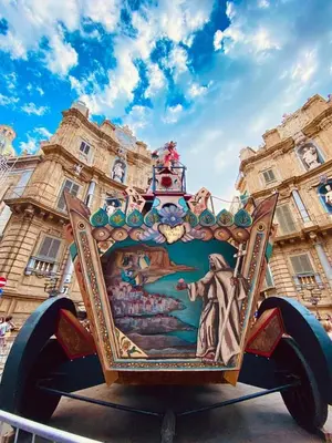 a cart with a painting on it in front of a building at Il Siciliano home in Palermo