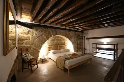 a bedroom with a bed and a brick wall at Il Siciliano home in Palermo