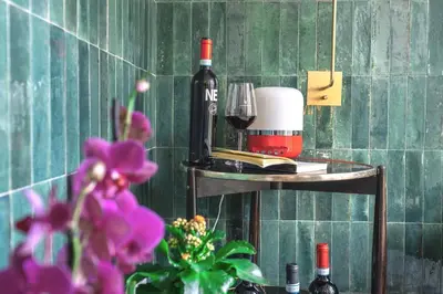 a bottle of wine and a glass on a shelf at Archè Design Rooms and Suites in Palermo