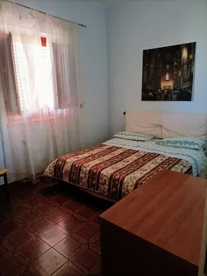 a bedroom with a bed and a table in it at LA FINESTRA SUL MARE in Trappeto