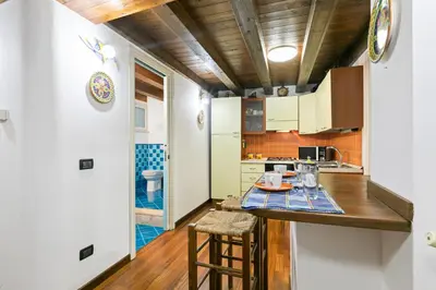 a kitchen with a table and chairs in a room at Vittorio Emanuele & Via Roma Colorful Apartment in Palermo