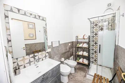 a bathroom with a tub and a toilet and a sink at Casa Raffadali, in centro storico a Palermo in Palermo