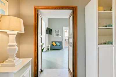 a mirror in a hallway with a living room at GuestHost - Stylish Flat Maqueda in Palermo