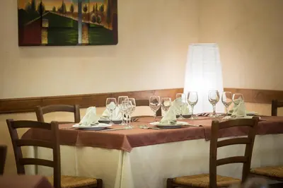 a table with wine glasses and napkins on it at Valle Himara in Piana degli Albanesi