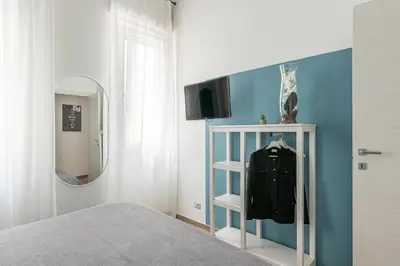 a bedroom with a bed with a mirror and a shelf at Maqueda House in Palermo