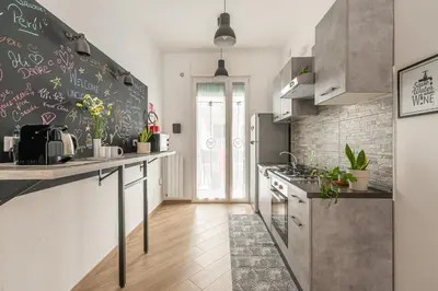a kitchen with a chalkboard on the wall at Maqueda House in Palermo