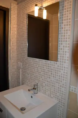 a bathroom with a white sink and a mirror at B&B Abbacò in Palermo