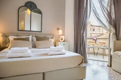 a bedroom with a bed with a mirror and a window at B&B Abbacò in Palermo