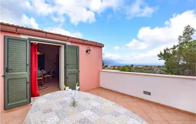 a table on the balcony of a house at Stunning Home In Castellammare Del G in Castellammare del Golfo