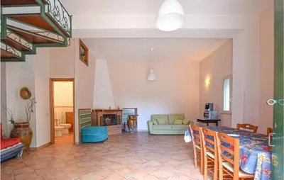 a living room with a table and a fireplace at Stunning Home In Castellammare Del G in Castellammare del Golfo