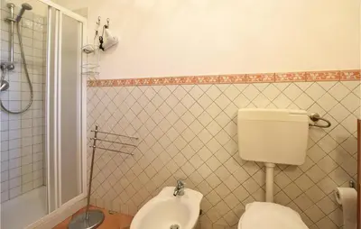 a bathroom with a toilet and a sink and a shower at Stunning Home In Castellammare Del G in Castellammare del Golfo