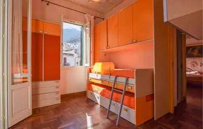 a room with orange cabinets and a bed in it at Cozy Apartment In Castellammare Dg in Castellammare del Golfo
