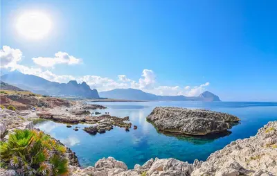 a view of a body of water with rocks at Cozy Apartment In Castellammare Dg in Castellammare del Golfo