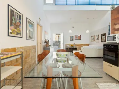 a kitchen and living room with a glass table at Apartment in Alcamo near the Beach in Alcamo Marina